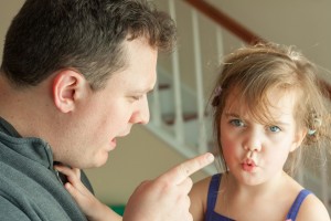 Dad disciplining young girl