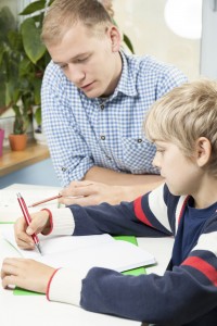 ADHD tutor helping child with ADHD with homework