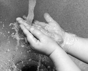 kid with OCD washing hands