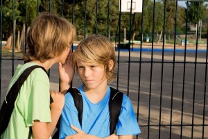 kid whispering in other kids ear