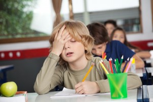 kid with ADHD trying to concentrate in classroom