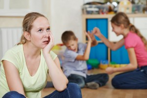 Mother annoyed with kids misbehaving and not listening in background