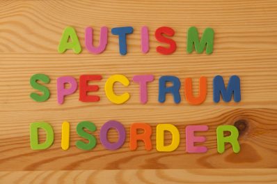 Children letter magnets spelling out Autism Spectrum Disorder