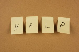Post-it notes written "help" on bulletin board