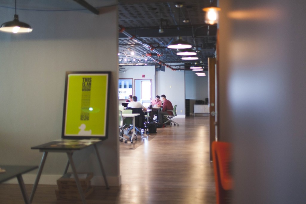 A workplace with people in a seminar in the background.