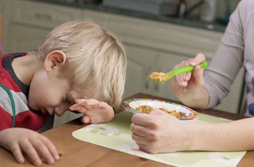 young boy with a Feeding Problem, picky eater not enjoying food