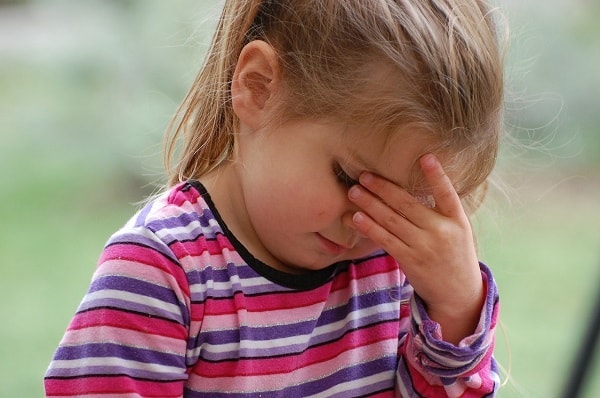 young anxious child with head down