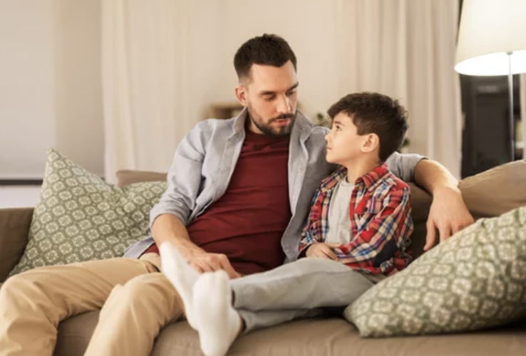 Father sitting down with son talking about good/bad touch