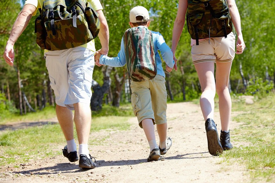 parents with young boy on a hike trail