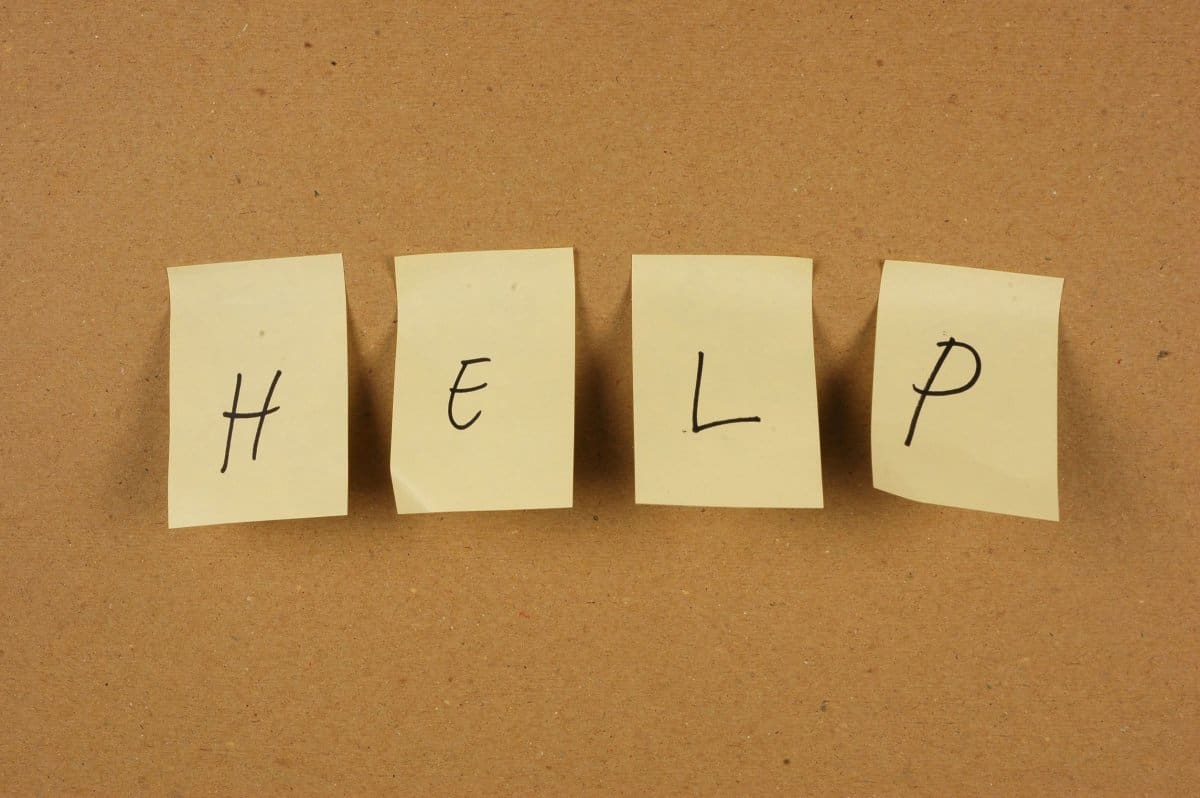 Post-it notes with the word "help" on bulletin Board 