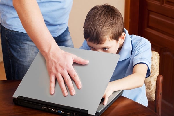 Parent closing child's laptop to stop the risk of Exploitation