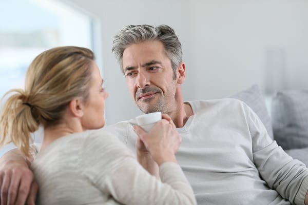 Mature couple talking together in sofa