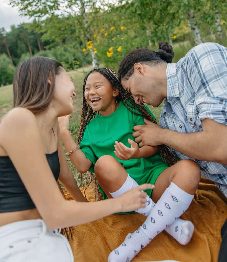 Parents laughing with their 10 year old daughter.