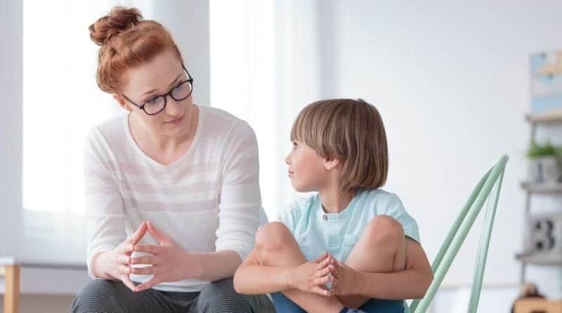 ABA therapist talking to Stressed child.