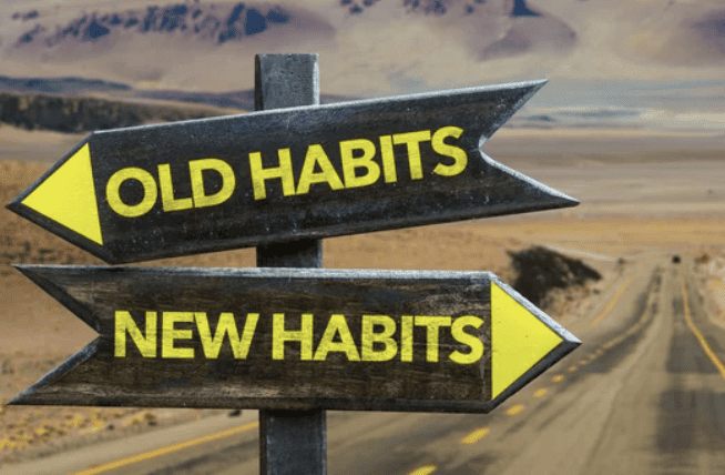Sign pointing in two directions, old habits and new habits.