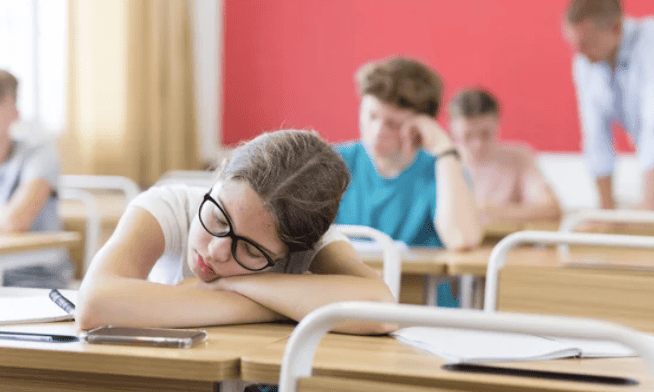 Teen falling asleep in class.