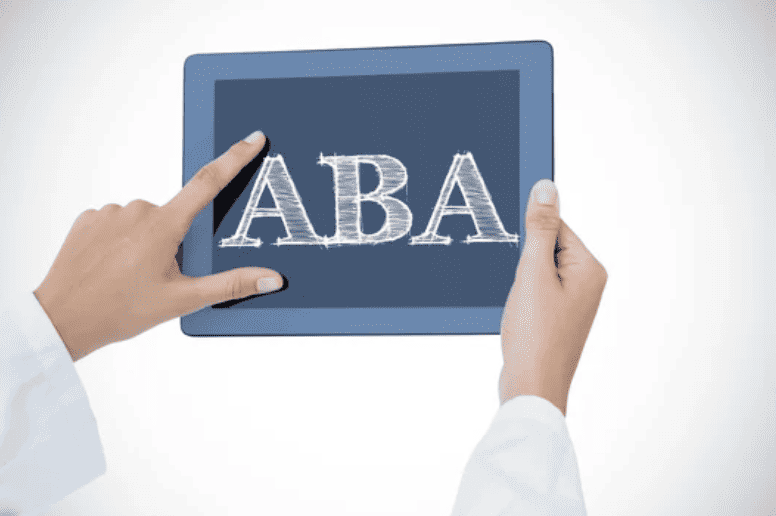 Close of someone holding Tablet with ABA on screen.
