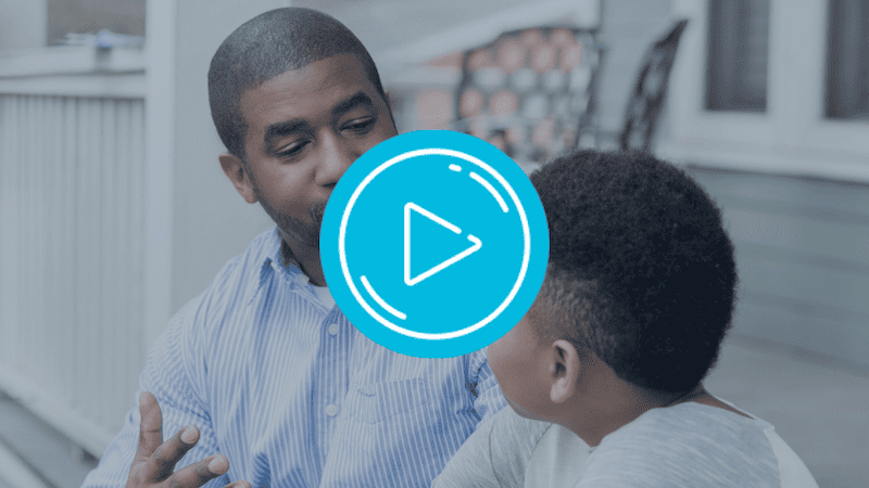 Father talking to son about his actions without yelling but calmly.