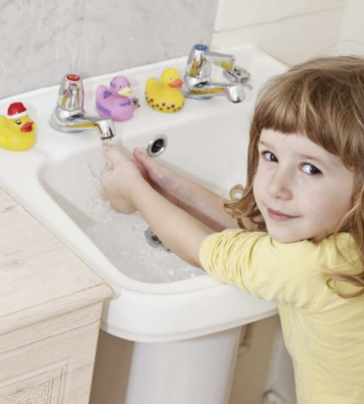 young girl Toilet Training washing her hands.