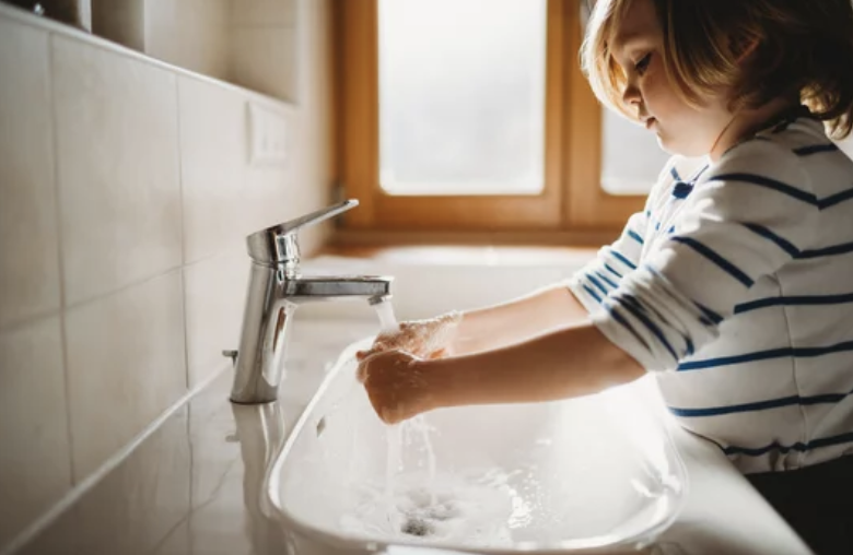 Young Child with OCD washing his hand consistently.