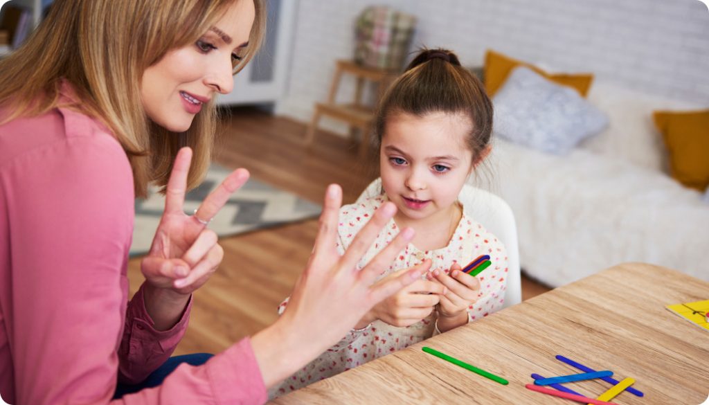 Psychologist helping little girl with activity in session