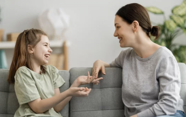 Psychologist speaking to Young girl in support group