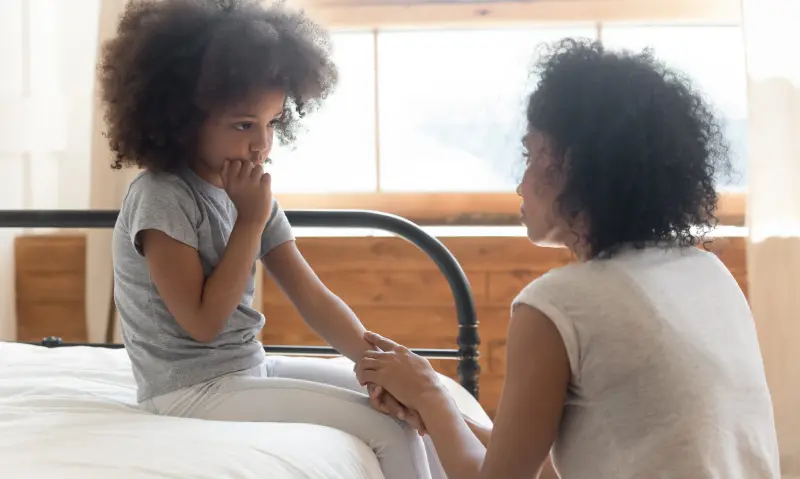 mom comforting little girl with anxiety