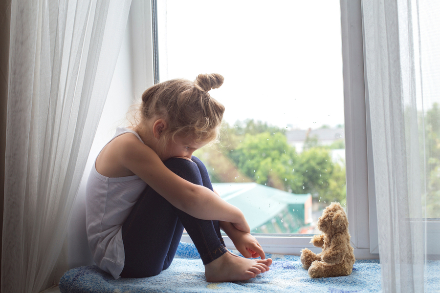 distressed Little girl with teddy bear